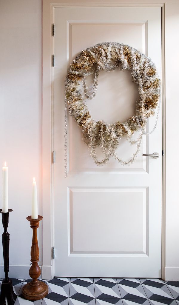 DIY wreath made from vintage tinsel hanging on door.