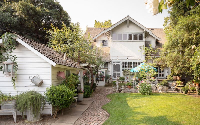 California backyard with vintage garden and sitting spaces.