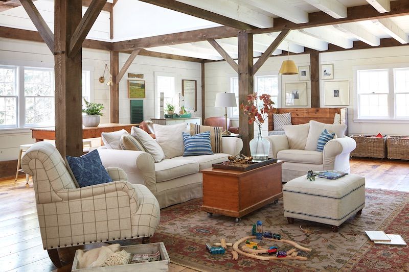 Casual living room with vintage furniture and wood beams.