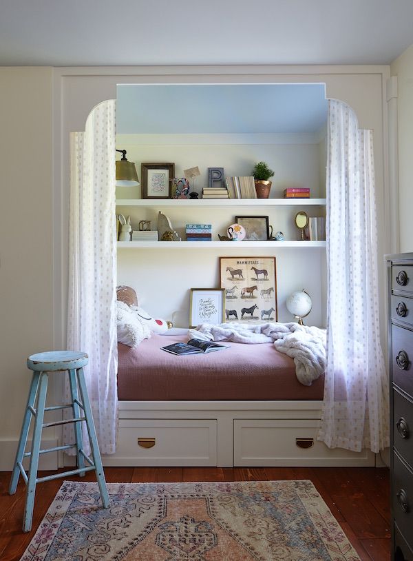 Kid's bedroom with nook and platform bed and vintage accessories.