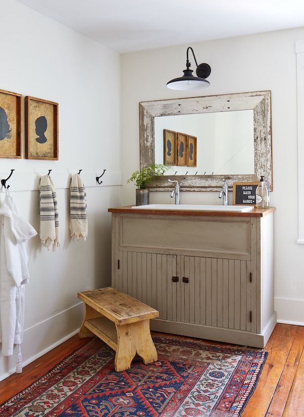 Bathroom with vintage style and kids' silhouettes on wall.